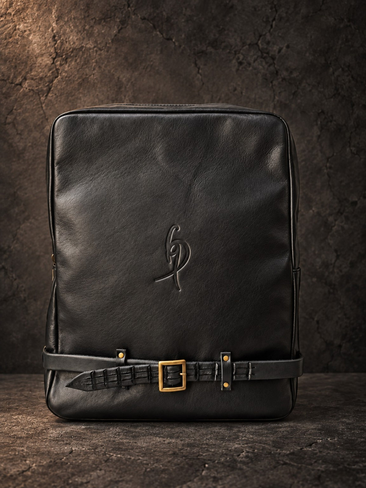 Close-up of crocodile-embossed black leather strap and brass buckle on leather backpack