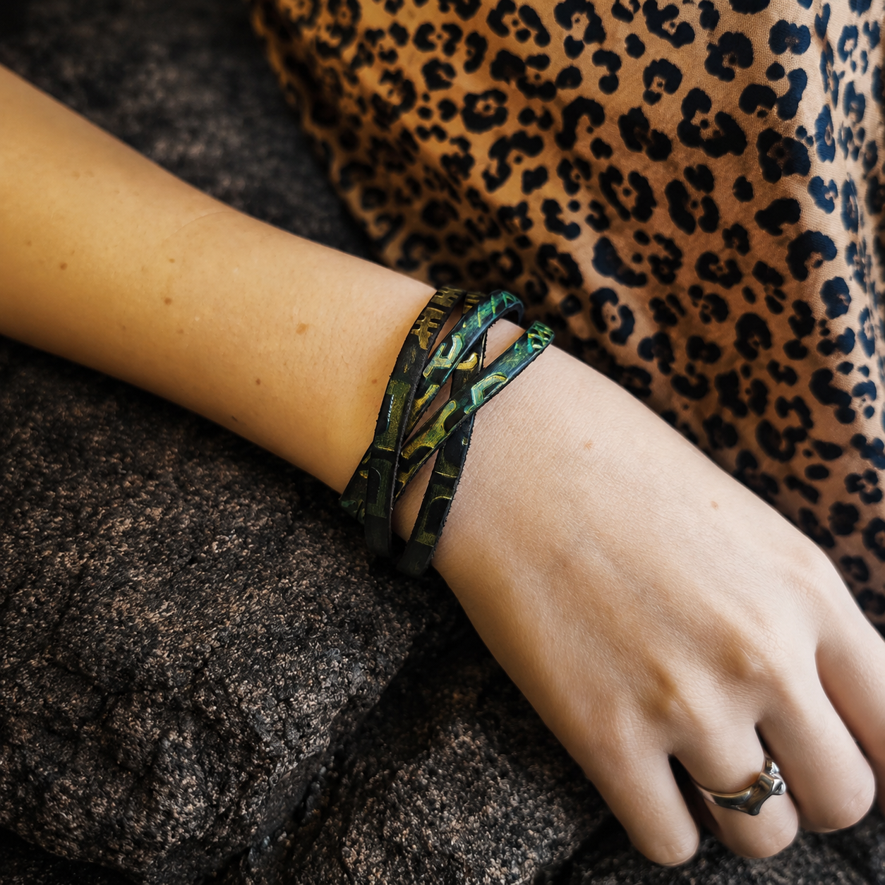Brown leather wrap bracelet with golden and turquoise engraving and a silver clasp