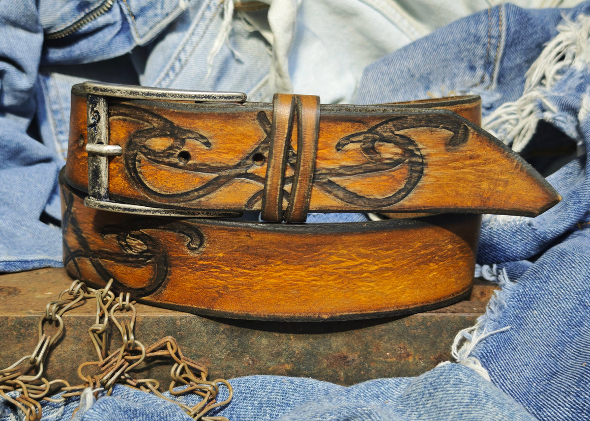 Brown leather belt with a metal buckle embossed with a unique decorative pattern β ISHAOR