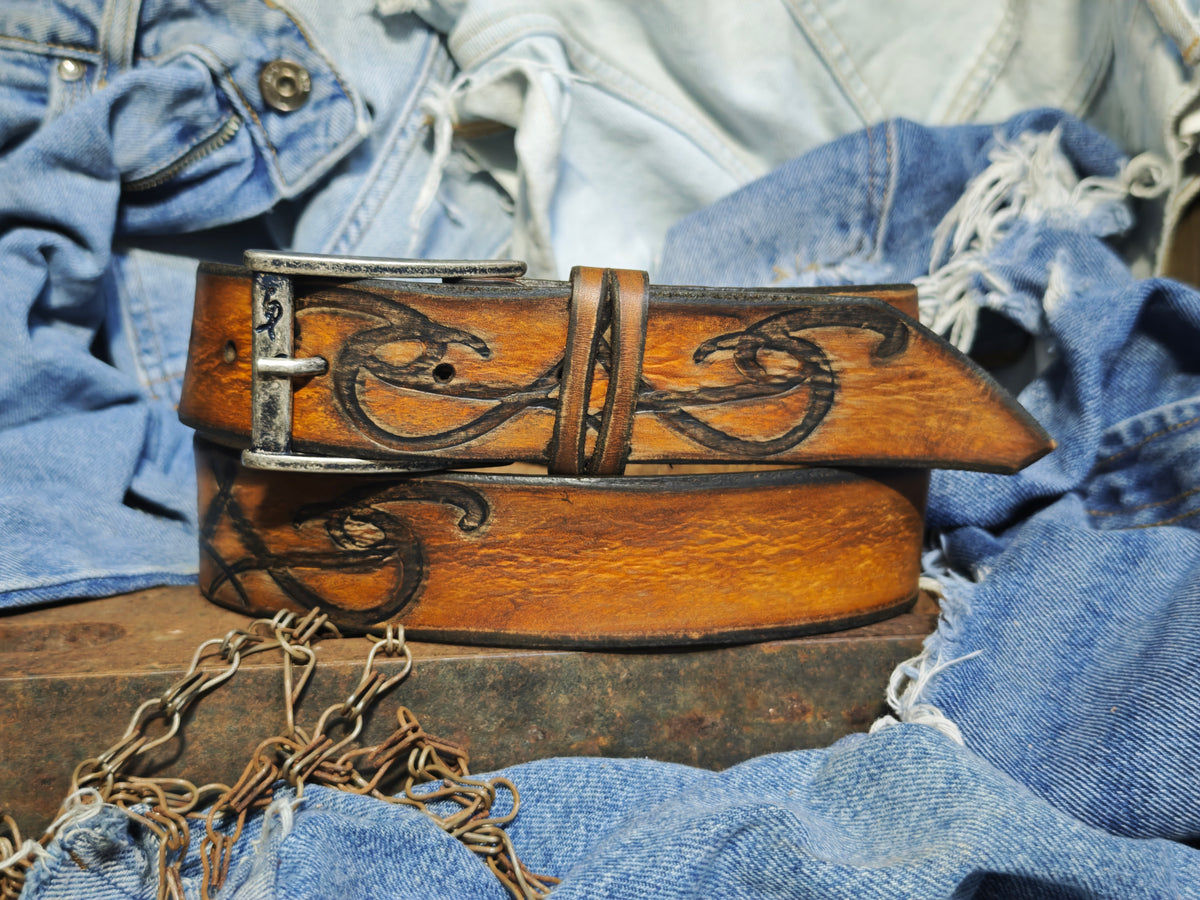 Brown leather belt with a metal buckle embossed with a unique decorative pattern β ISHAOR