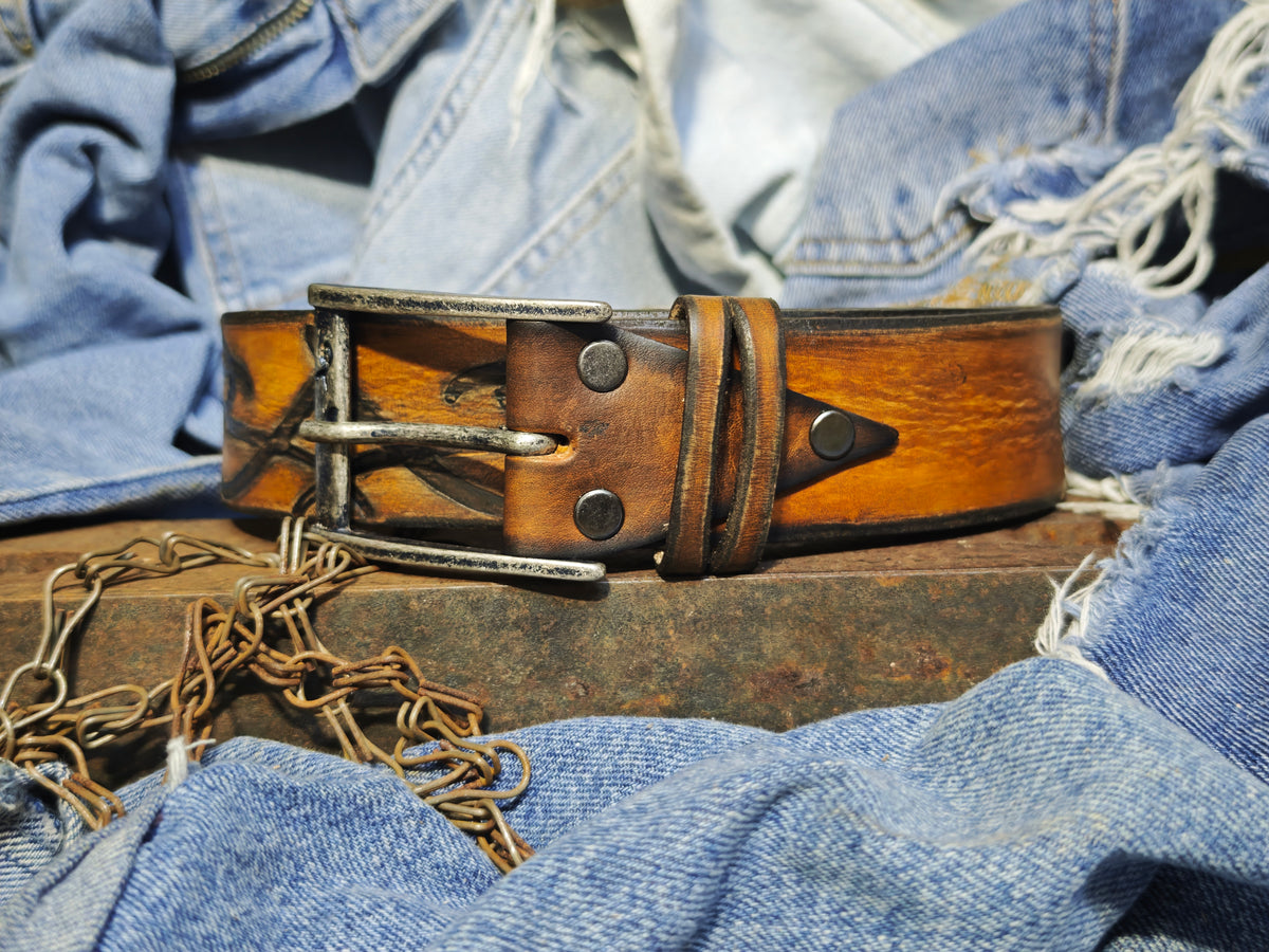 Brown leather belt with a metal buckle embossed with a unique decorative pattern β ISHAOR