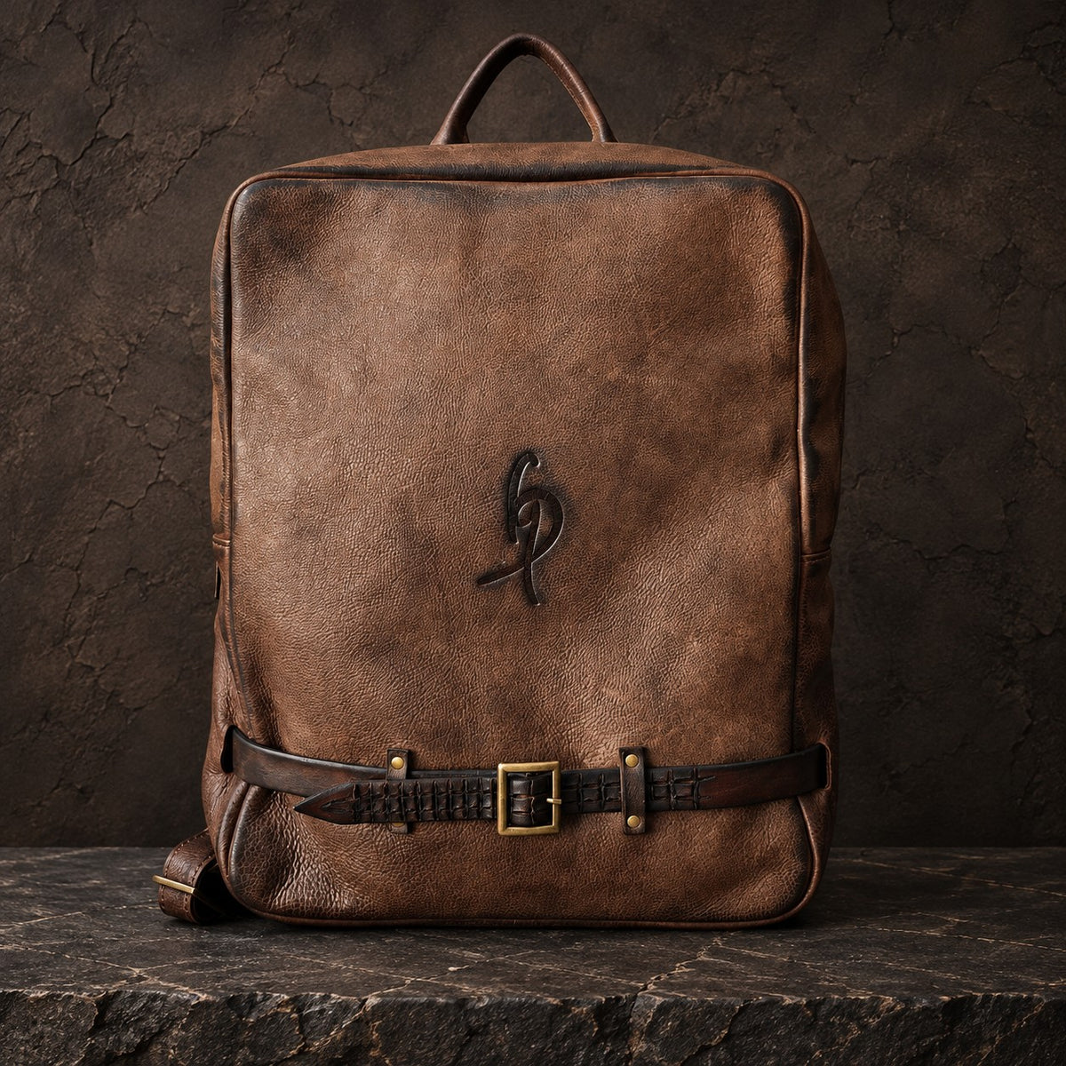 Brown leather laptop backpack with hand-sculpted crocodile-pattern leather strap and brass buckle