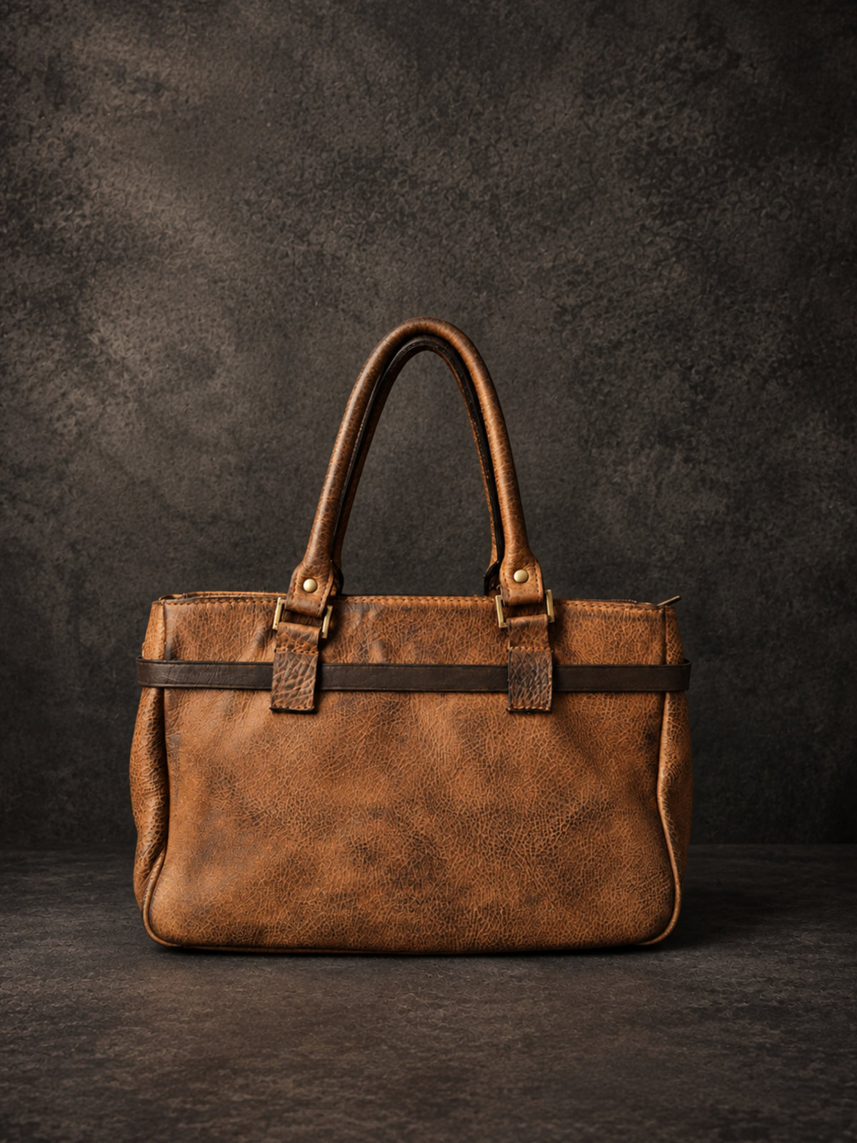 Back view of the cognac heritage leather bag with leather belt detail