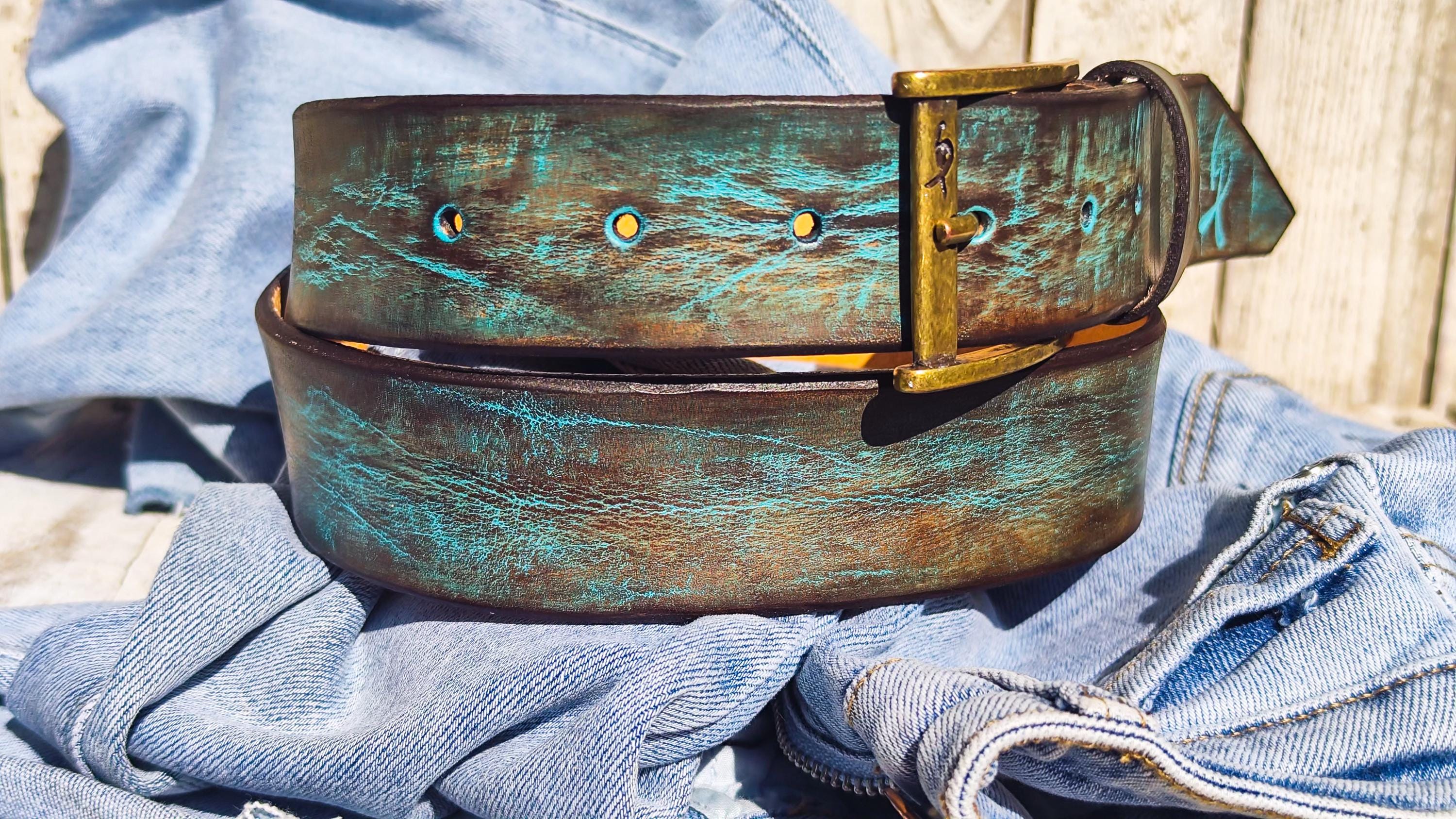 One-of-a-kind textured leather belt with rugged buckle and custom finish.
