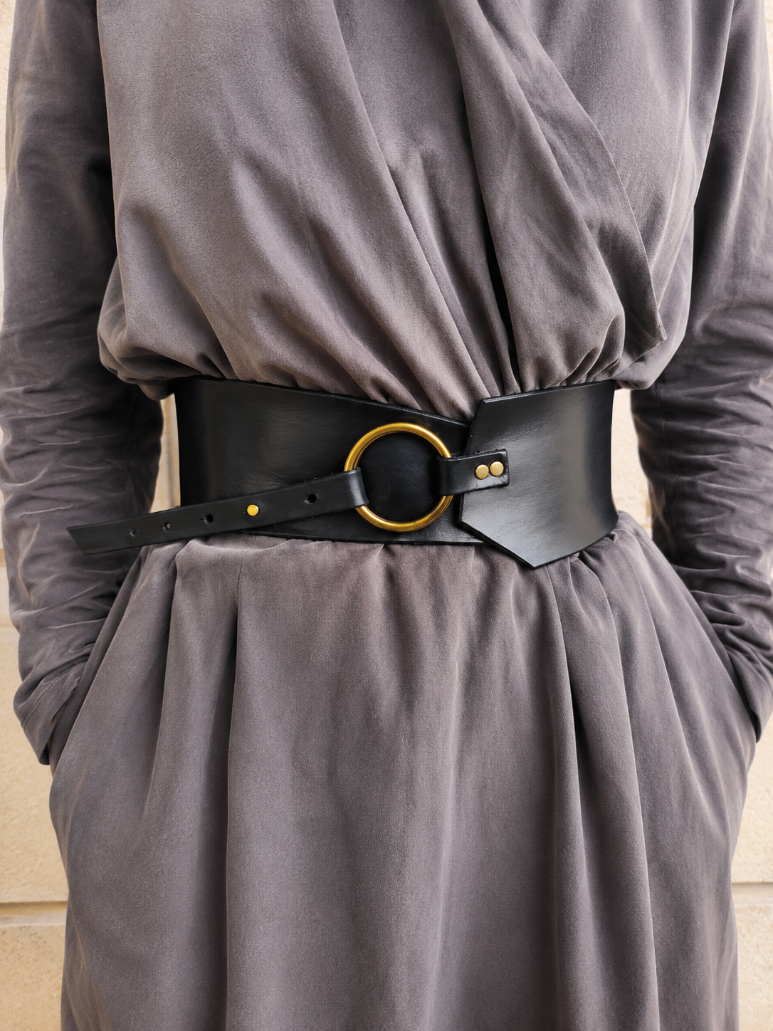 Black leather waist belt with asymmetrical design and bronze Ring. Black dress corset for women, wide leather belt