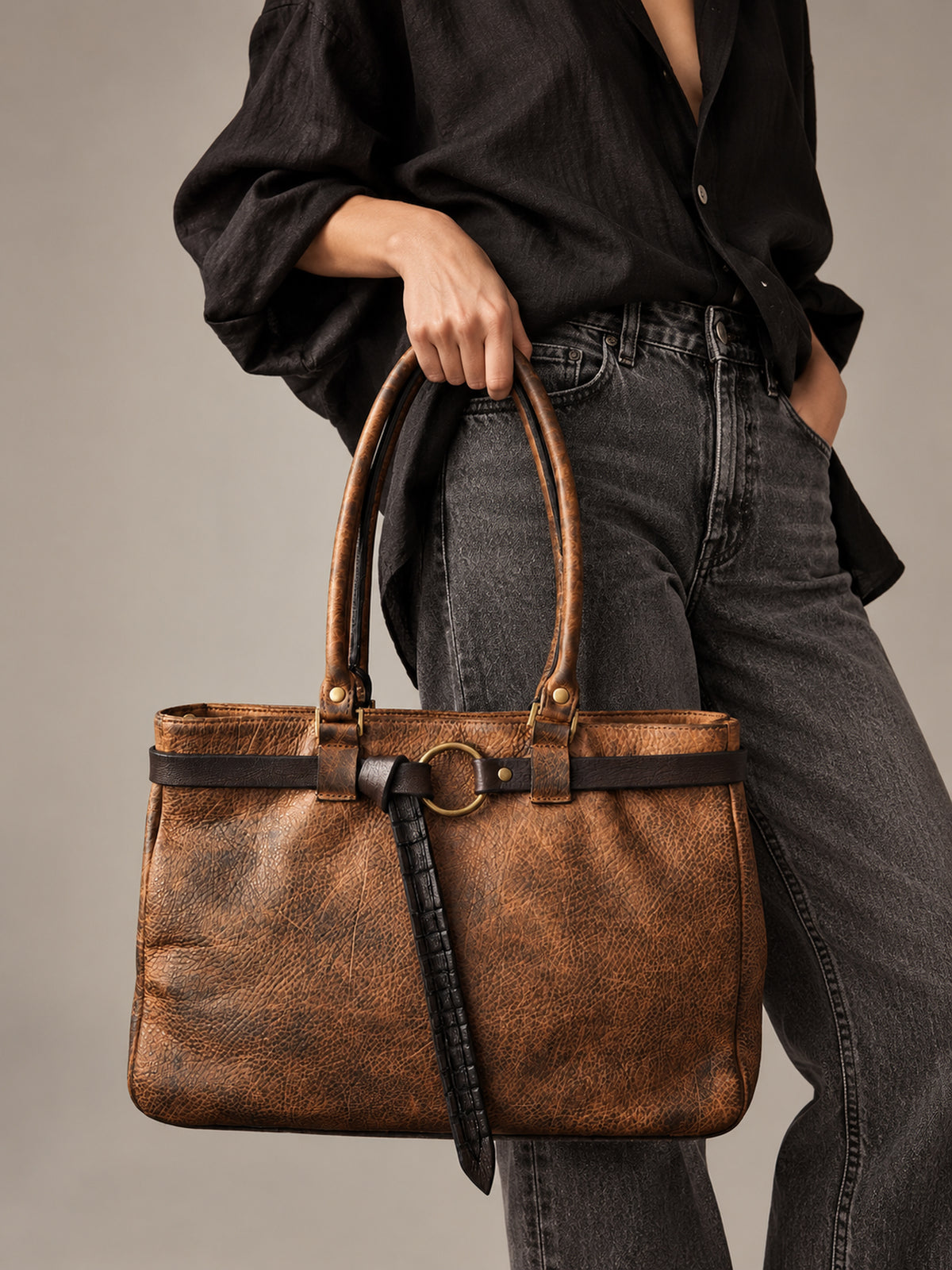 Woman carrying large hand-dyed brown leather tote bag with black crocodile-embossed belt – ISHAOR