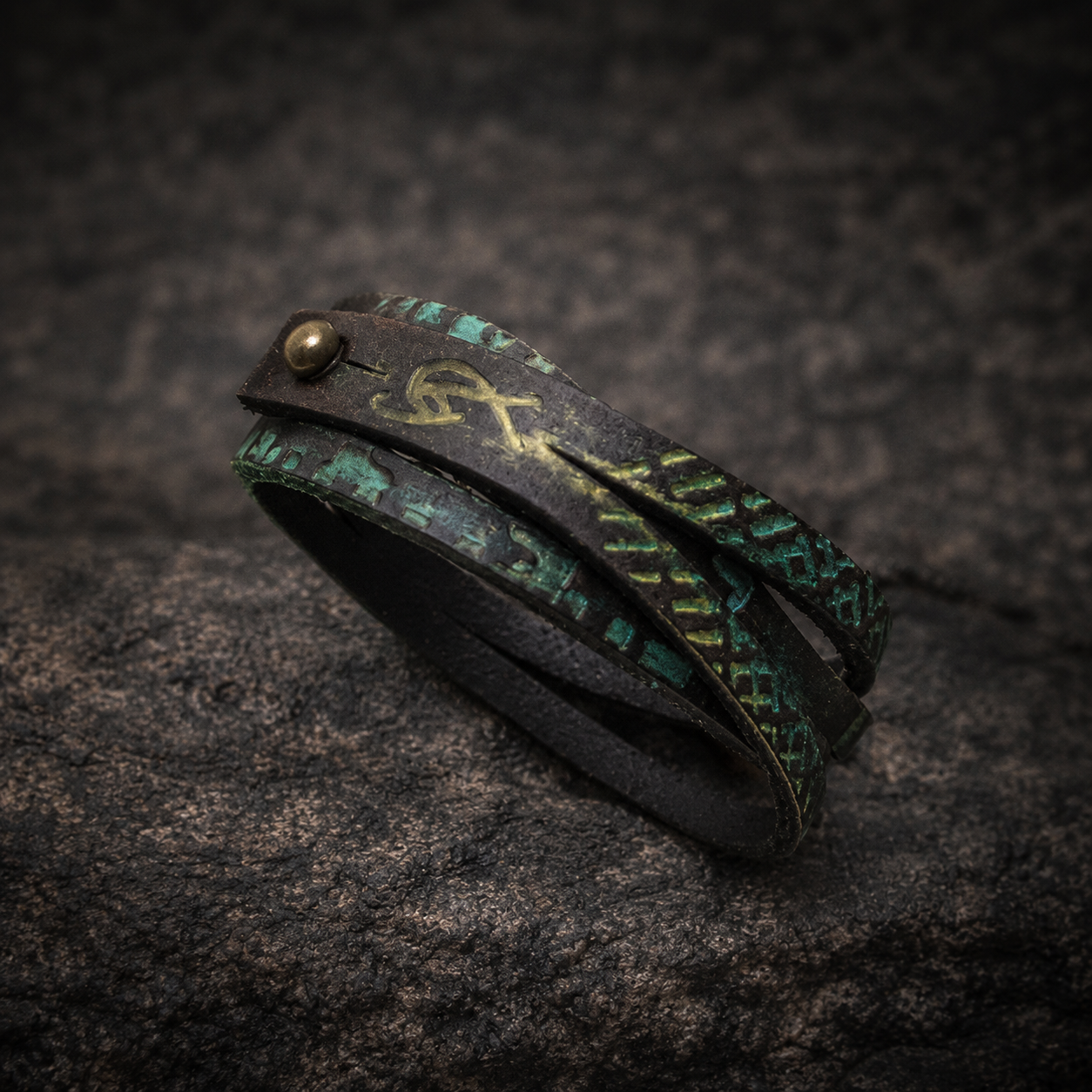 Brown leather wrap bracelet with golden and turquoise engraving and a silver clasp
