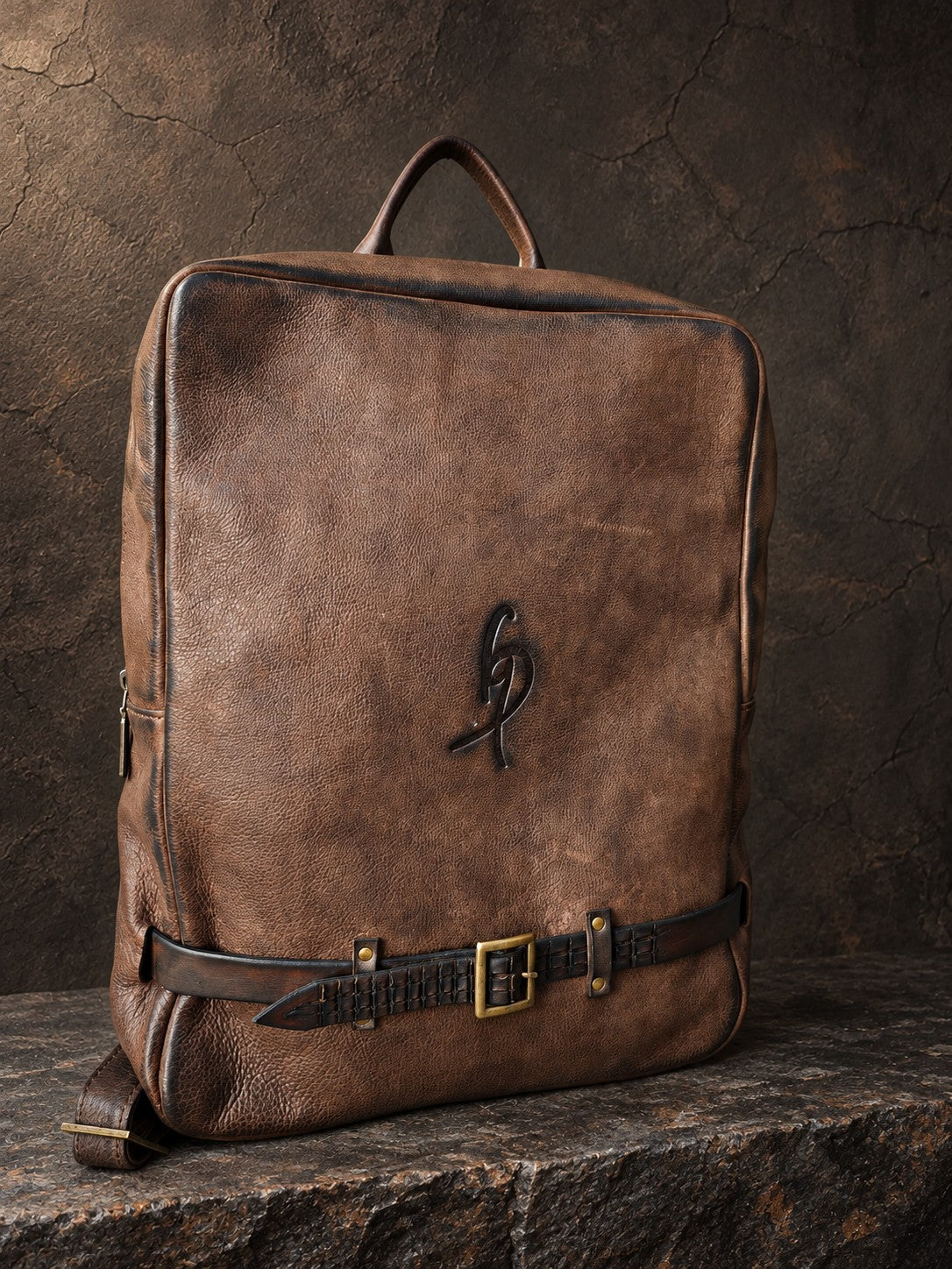 Brown hand-dyed leather laptop backpack, angled view showing embossed ISHAOR logo and sculpted crocodile strap