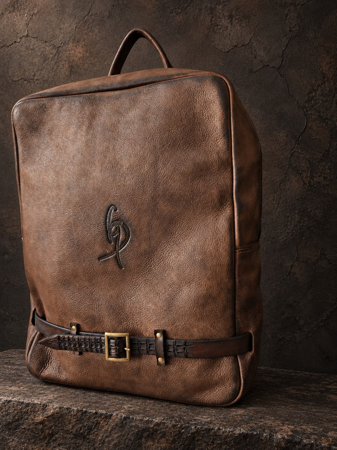 Brown leather laptop backpack angled side view, handmade genuine leather work bag