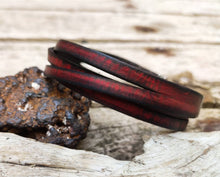 Red bracelet with black wash and silver clasp