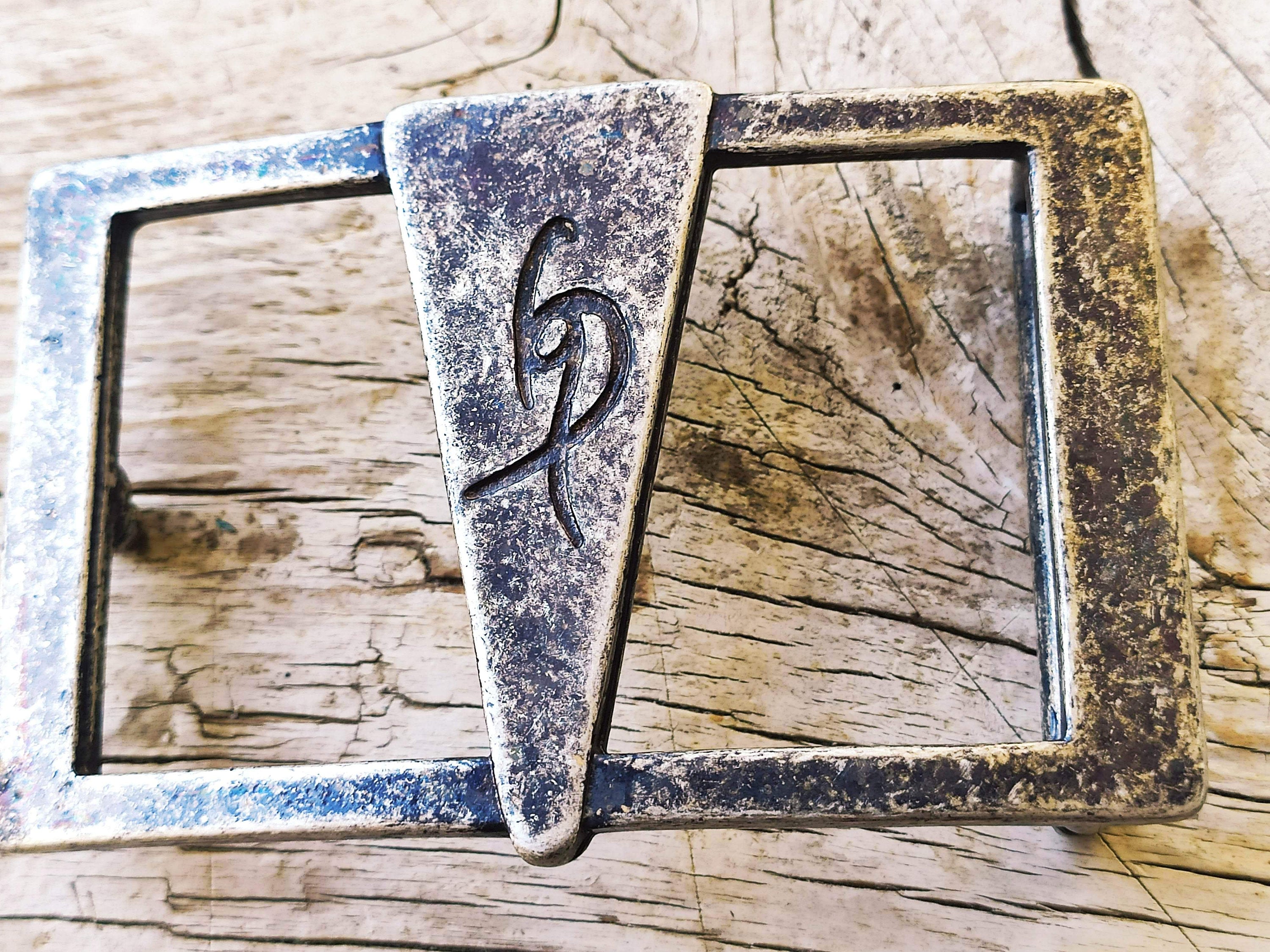 a Ishaor original buckle square buckle with a triangle in the center and Ishaor logo on it ,stunning buckle that will upgrade any belt