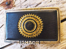 a Ishaor original square buckle with dark brown leather inside & motorcycle gear stamp in gold  ,stunning buckle that will upgrade any belt