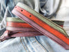 A colorful and summery belt made from three layers of pastel colors orange turquoise and purple  fits with jeans and refreshes any outfit